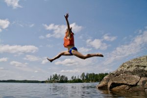 woman jumping into water